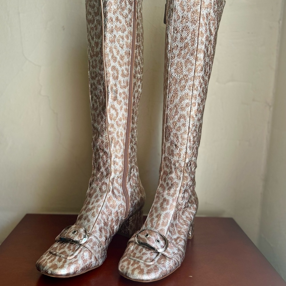 Kate Spade metallic copper and silver leopard print knee-high buckle boots.